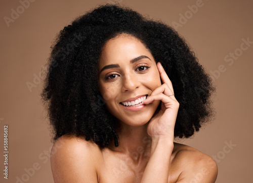 Black woman, studio portrait and smile with beauty, makeup and cosmetic wellness with hands, face or natural hair. Model, soft skin and facial cosmetics, self care and afro by brown studio background