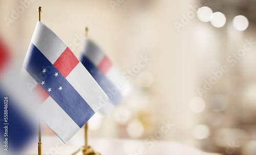 Small flags of the Netherlands Antilles on an abstract blurry background