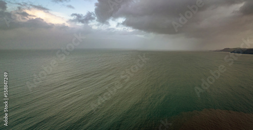 Clouds and rain over the ocean along the Welsh coastal path and coastline.