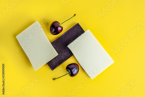 Принти на полотні English Morello Cherries with white and dark cocoa chocolate isolated on a yello