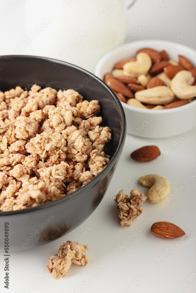 Granola in bowl on light background. Granola in bowl on light background.