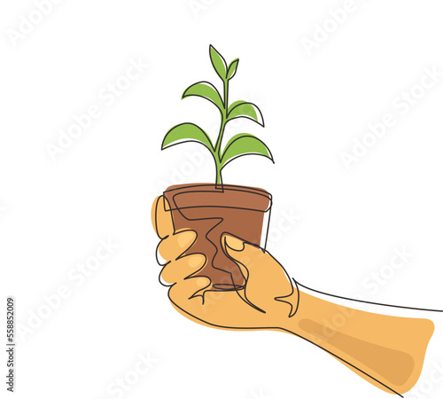Continuous one line drawing agronomist holding seedlings in peat pots. Female hands touching the plants for planting tree. The spring planting. Single line draw design vector graphic illustration