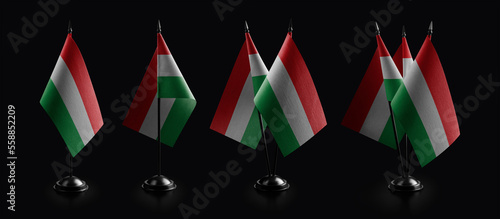 Obraz na plátně Small national flags of the Hungary on a black background