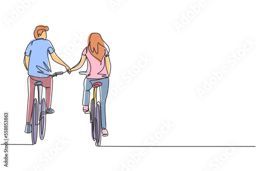 Single one line drawing happy couple ride bicycles in meadow back to camera and holding hands. Young man and woman in love. Happy romantic married couple. Continuous line draw design graphic vector