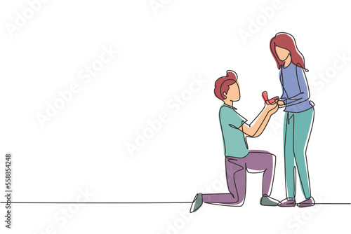 Continuous one line drawing man kneeling holding engagement ring proposing woman marry him happy marriage wedding concept. Guy on knees proposing girl to marry. Single line draw design vector graphic