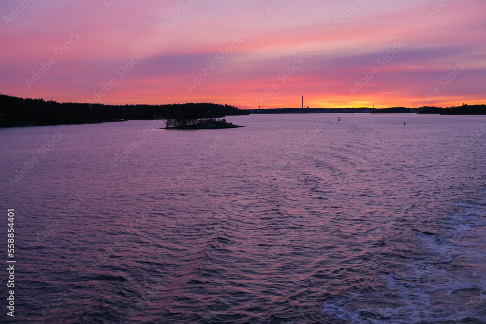 Bright magenta and violet sunset over Baltic Sea near Stockholm, Sweden