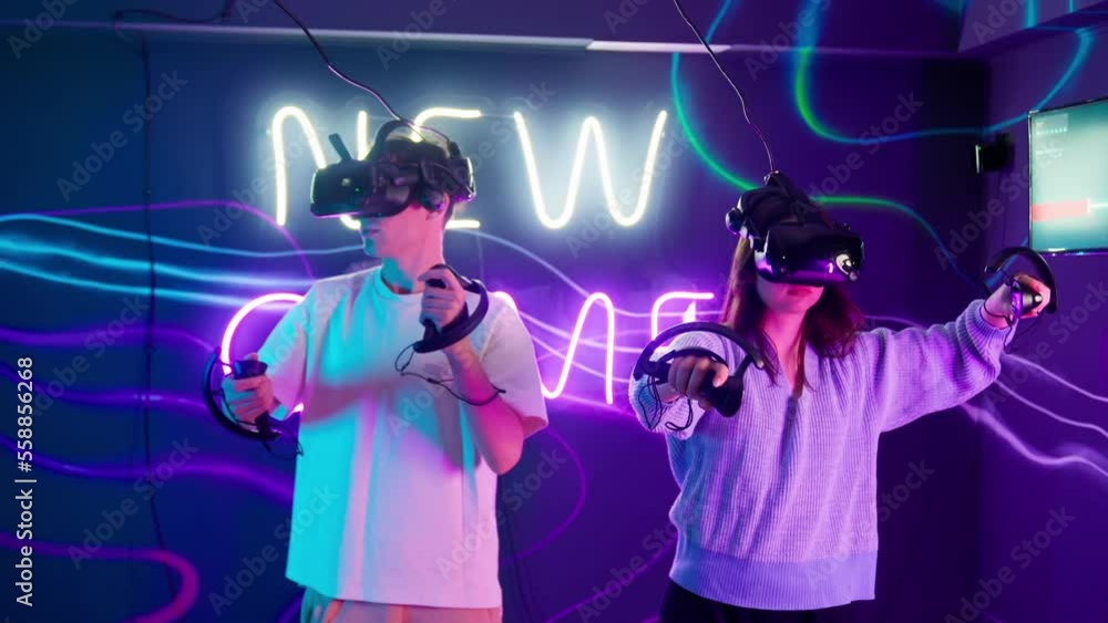 Cyber gamer in VR glasses plays virtual reality game in neon futuristic ...