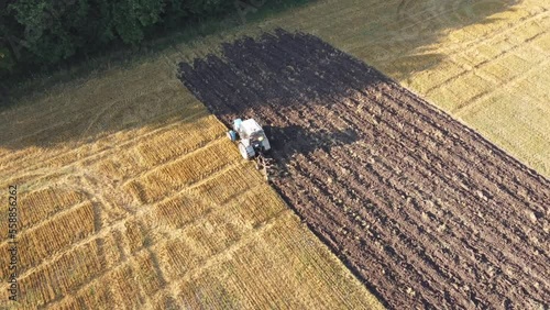 farm tractor plows the field and prepares for sowing