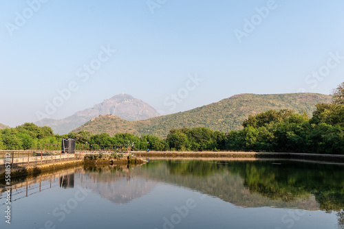 Reflection of the beautiful Girnar mountain range and peak in the waters of a lake in the town of Junagadh.