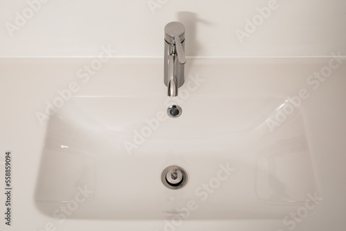 White bathroom sink with chrome faucet. Hygiene