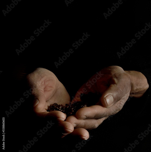 man praying with hands on black background with people stock photo