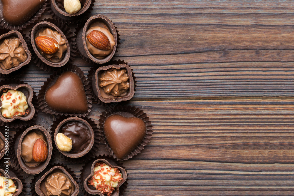 Different kinds of chocolates on colored table close-up. Top View and Flat Lay with copy space Different kinds of chocolates on colored table close-up. Top View and Flat Lay with copy space
