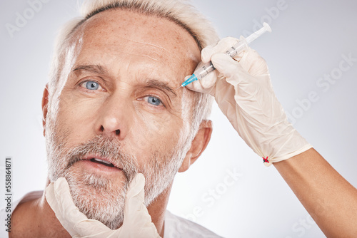 Botox, face and portrait of a senior man doing a cosmetic anti aging treatment in the studio. Plastic cosmetology, filler and elderly guy with wrinkles getting a silicone injection by gray background photo