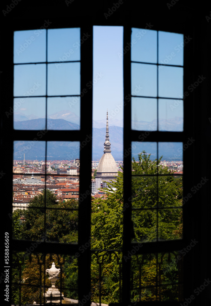Fototapeta premium Turin - Italy - Urban skyline with Mole Antonelliana building, blue sky and Alps mountains.