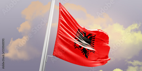 Albania national flag cloth fabric waving on the sky - Image