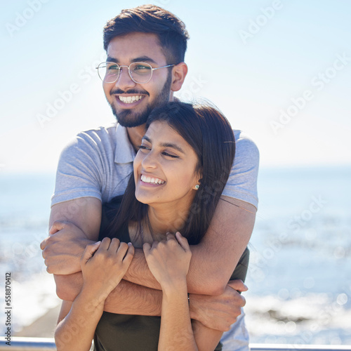 Fotografie Love, ocean and happy couple hug, relax and enjoy outdoor quality time together for peace, freedom and romantic date