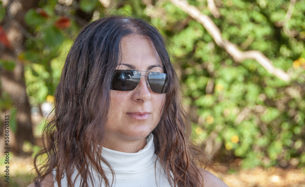Portrait of a happy caucasian woman relaxing on a forest hike Portrait of a happy caucasian woman relaxing on a forest hike