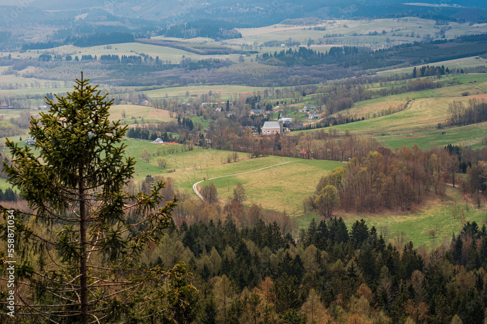 Obraz premium A romantic view of the beautiful valleys and arable fields from the Stołowe Mountains, a distant view to the horizon, a large space that gives a sense of freedom and independence. Polish Karkonosze, b