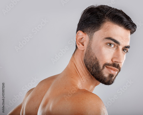 Skincare, health and man in a studio for a hygiene, wellness and natural cosmetic face routine. Beauty, cosmetics and male model from Dubai with self care facial treatment isolated by gray background