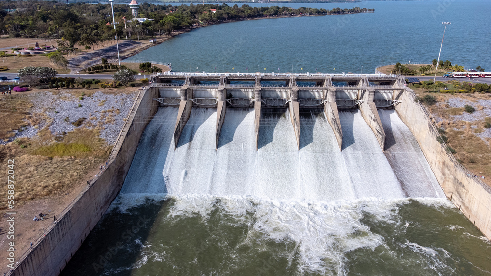 An aerial view over the Pasak Jolasid dam, Lopburi Province, Thailand. Tracking the movement of the floodgates that are releasing water into rural canals in enormous amounts of water. An aerial view over the Pasak Jolasid dam, Lopburi Province, Thailand. Tracking the movement of the floodgates that are releasing water into rural canals in enormous amounts of water.