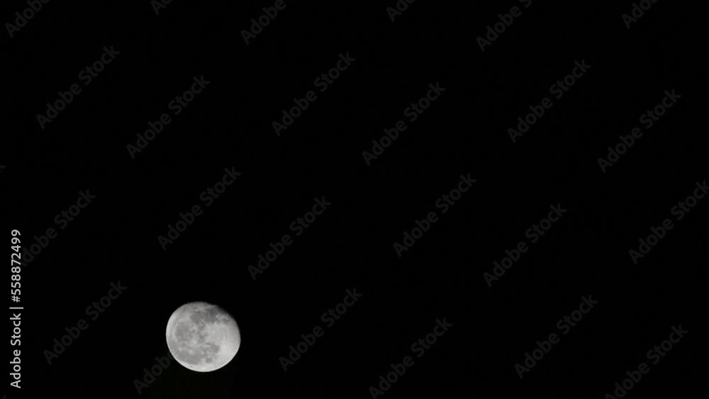 Moon Timelapse, Stock time lapse : Full moon rise in dark nature sky, night time. Full moon disk time lapse with moon light up in night dark black sky. High-quality free video footage or timelapse