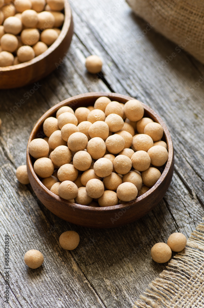 Brown Soy-covered Chickpeas with sauce in wooden bowl, traditional turkish coated nut Brown Soy-covered Chickpeas with sauce in wooden bowl, traditional turkish coated nut