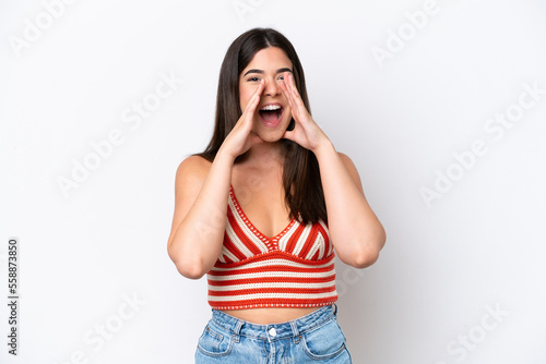 Young Brazilian woman isolated on white background shouting and announcing something