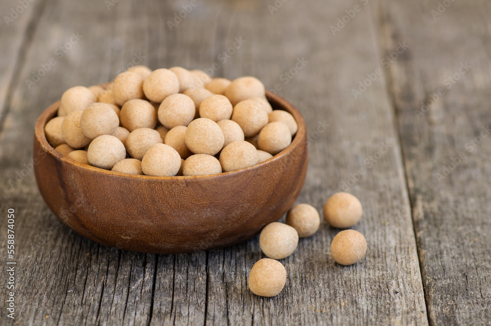 Brown Soy-covered Chickpeas with sauce in wooden bowl, traditional turkish coated nut Brown Soy-covered Chickpeas with sauce in wooden bowl, traditional turkish coated nut