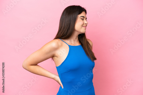 Young Brazilian woman isolated on pink background suffering from backache for having made an effort