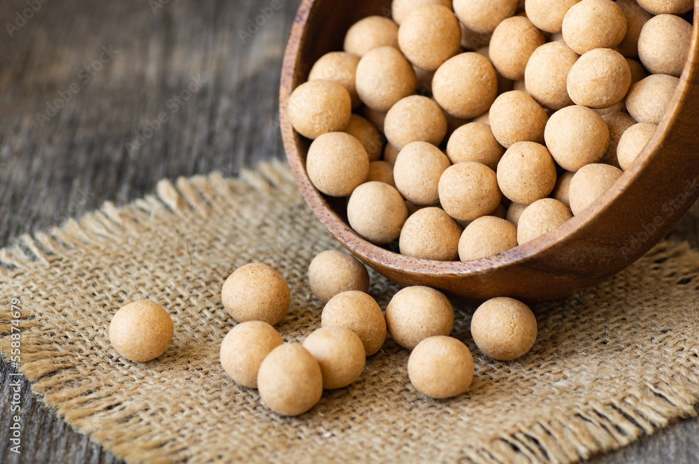 Brown Soy-covered Chickpeas with sauce in wooden bowl, traditional turkish coated nut Brown Soy-covered Chickpeas with sauce in wooden bowl, traditional turkish coated nut