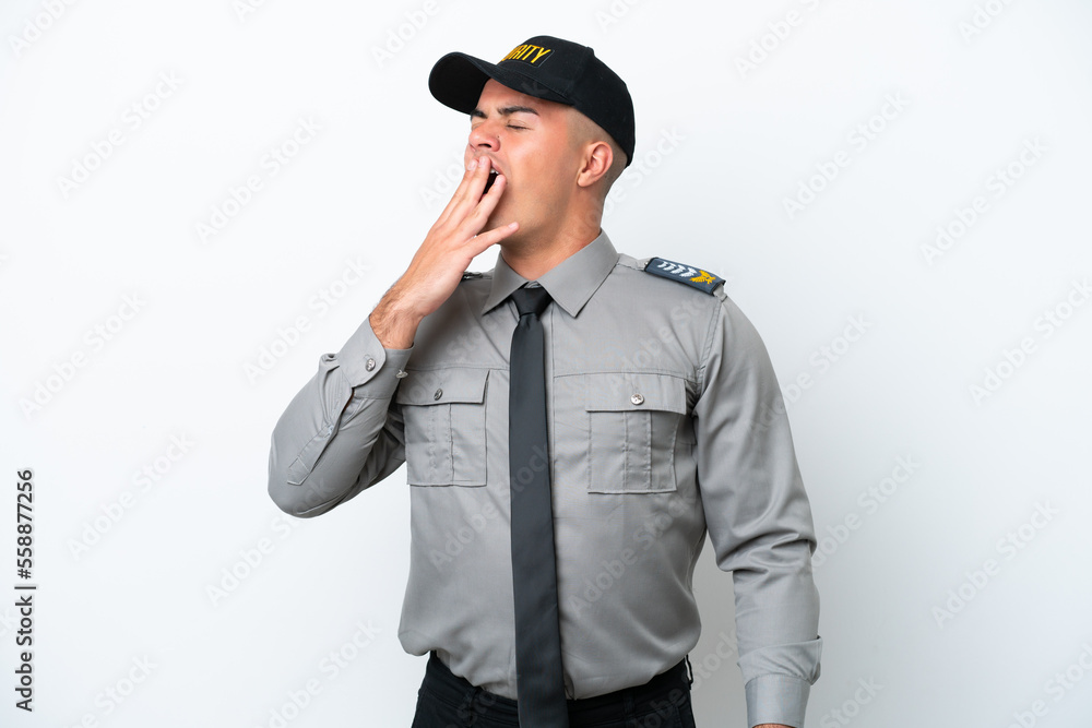 Young caucasian security man isolated on white background yawning and covering wide open mouth with hand Young caucasian security man isolated on white background yawning and covering wide open mouth with hand