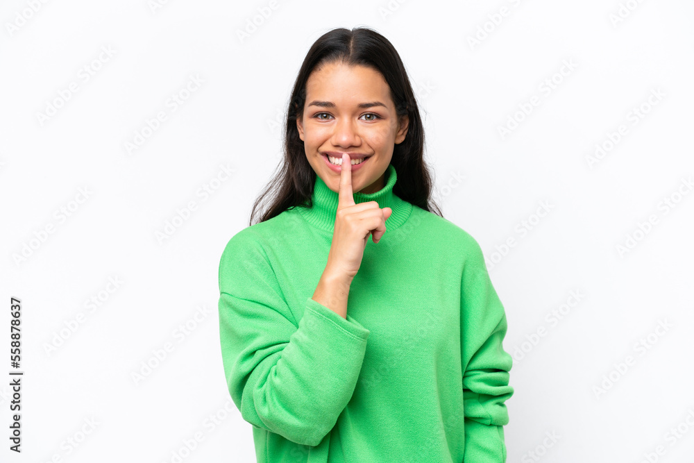 Young Colombian woman isolated on white background showing a sign of silence gesture putting finger in mouth Young Colombian woman isolated on white background showing a sign of silence gesture putting finger in mouth