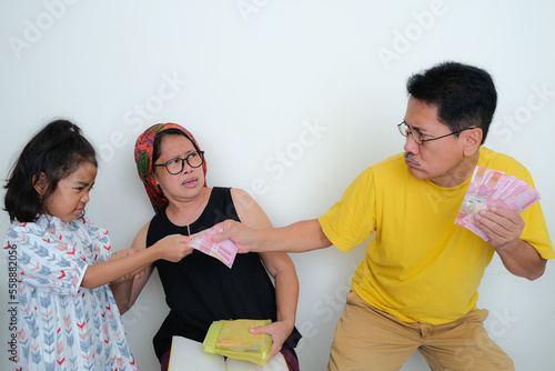 Father and daughter fighting for some money in their hands photo
