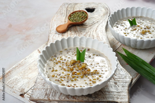 Indonesian traditional dessert.Bubur kacang ijo or Mungbean Porridge,serven in a bowl with coconut milk. photo