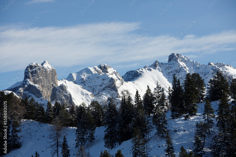 Beautiful panorama of high rocky mountains with snowy peaks against the blue sky and clouds. Brandnertal, Austria