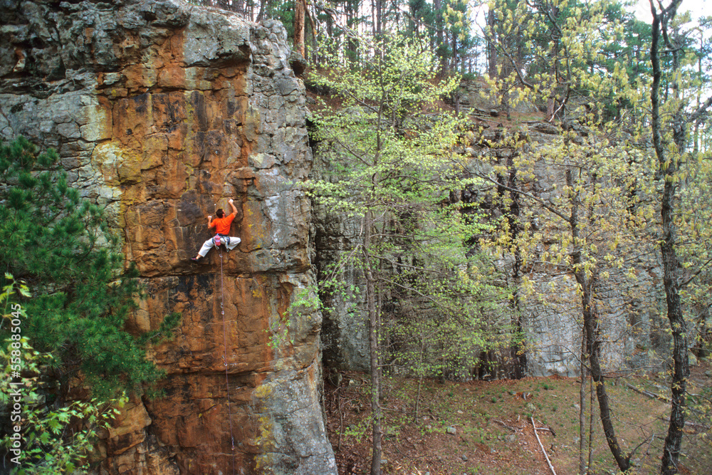 Male rock climber on sandstone in Arkansas. Male rock climber on sandstone in Arkansas.