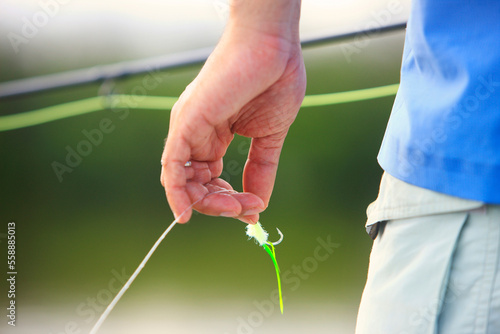Close up of a fly fisherman's hand holding a green line and fly on Grand Inagua in the Bahamas.