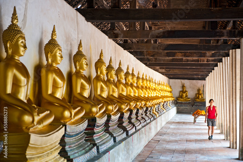 woman exploring the temple of Wat Phutthai Sawsn in Ayutthaya photo