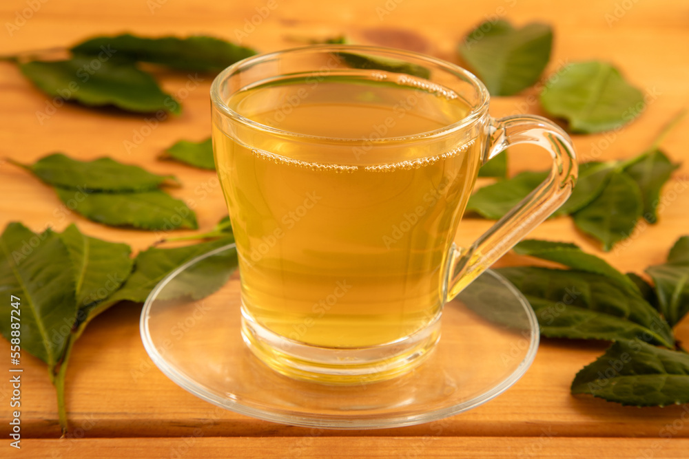Tea leaves with a glass cup of green tea,closeup Tea leaves with a glass cup of green tea,closeup