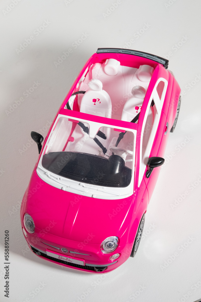 Kent, uk, 01.01.2023, A Barbie Pink Fiat 500 Car Sports Toy Vehicle  isolated on a white background. Modern barbie plastic fantastic pink doll  car. Famous doll toys for boys and girls. Photos