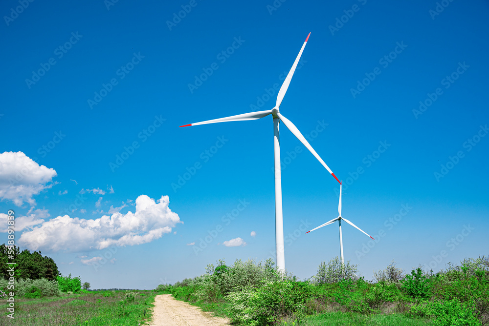 Wind farm outside the city against the blue sky. Wind farm outside the city against the blue sky.