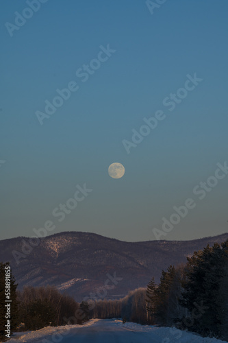 the moon over the hills and the road