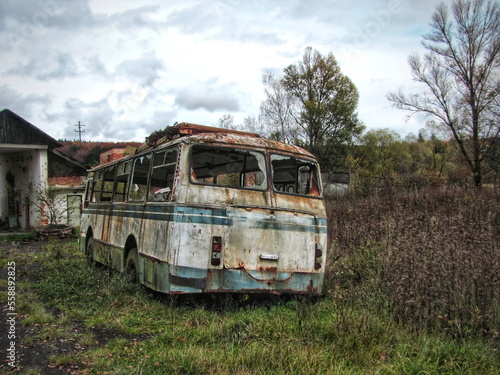 Abandoned destroyed bus on the outskirts of a motor vehicle enterprise in Ukraine