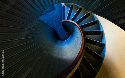 Murais de parede high angle photography of blue spiral staircase blue and black spiral staircase