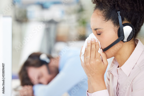 Customer service, call center and sick woman blowing nose in office workplace. Covid, cold and black female telemarketing employee, sales agent or consultant with tissue for flu, corona or covid 19.