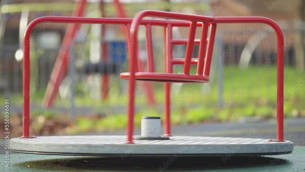 Children's roundabout spinning fast in an empty playground Children's roundabout spinning fast in an empty playground