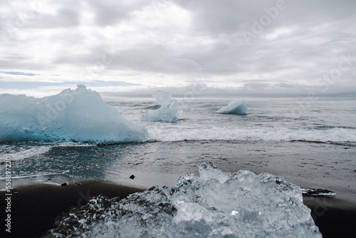 Chunks of ice washed up by the sea lie on the black beach of Breidamerkursandur ( Diamond Beach). They come from the broken icebergs from the glacier lagoon Jökulsárlón, which migrate into the sea. photo