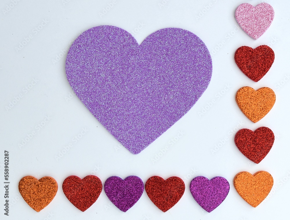 Obraz premium Valentines Day border of colorful paper hearts over a white background