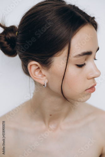 portrait of a young girl with clean skin without makeup, stylish minimalism and girlish beauty
