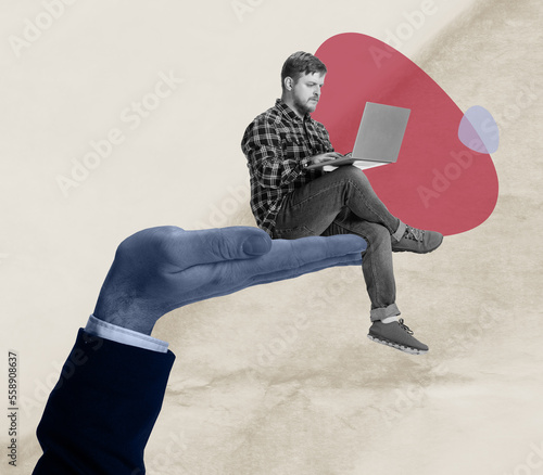 Young man sitting on huge male hand and working at laptop over light background. Contemporary art collage. Concept of remote work, education, freelance and support. photo